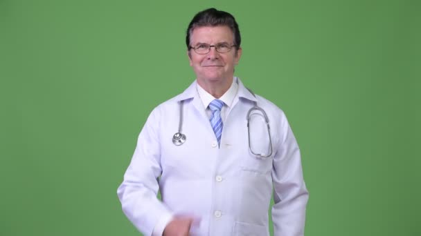 Senior handsome man doctor giving thumbs up — Stock Video