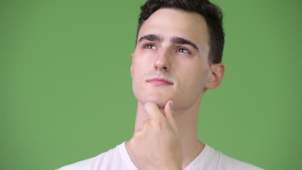 Young happy handsome man thinking — Stock Video