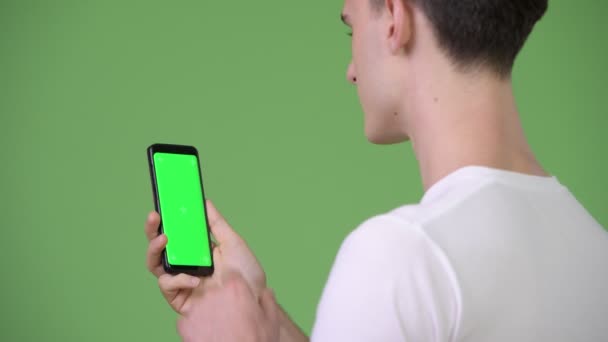 Vue du profil de jeune bel homme utilisant le téléphone — Video