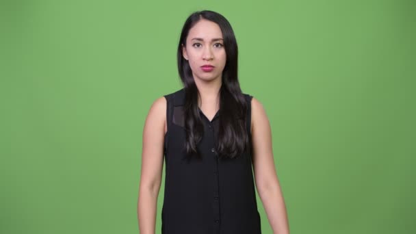 Young beautiful Asian businesswoman choosing between thumbs up and thumbs down — Stock Video