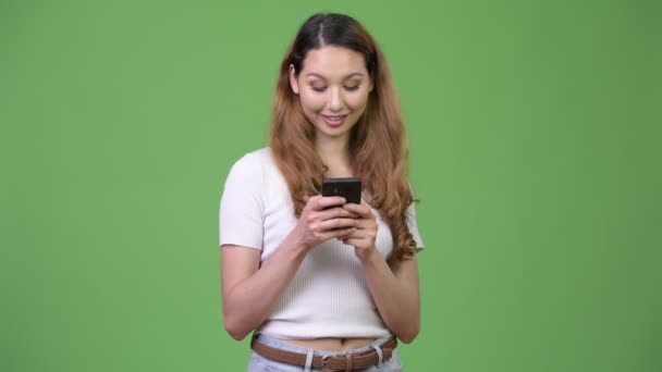 Jovem feliz bela mulher asiática usando telefone — Vídeo de Stock