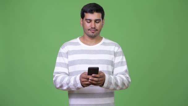 Young handsome Persian man using phone — Stock Video