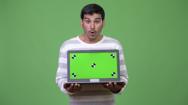 Young handsome Persian man showing laptop — Stock Video
