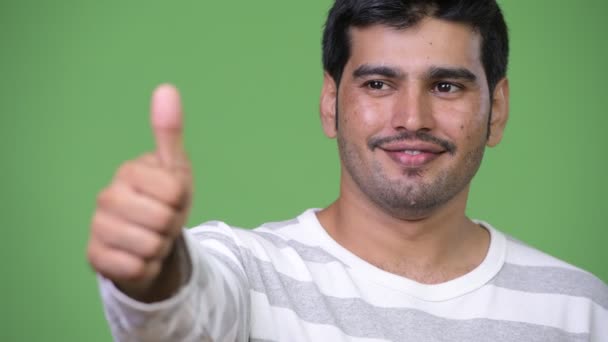 Young handsome Persian man giving thumbs up — Stock Video