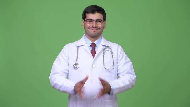 Young handsome Persian man doctor talking — Stock Video