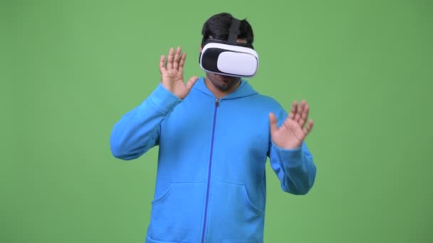 Joven hombre persa guapo usando auriculares de realidad virtual — Vídeo de stock