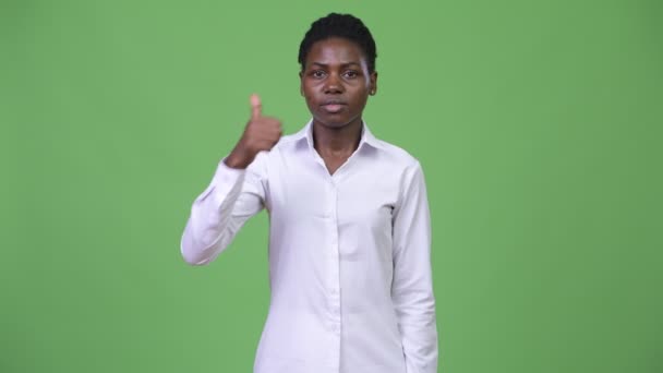 Young beautiful African businesswoman giving thumbs up — Stock Video