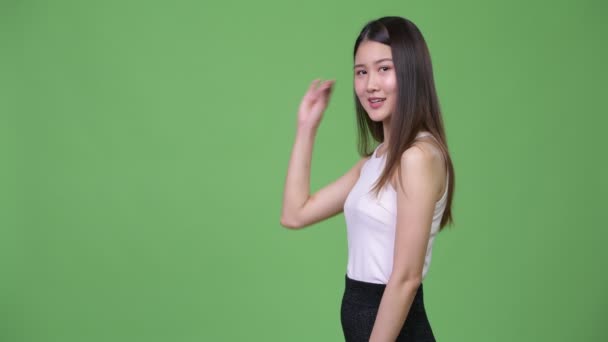 Young beautiful Asian businesswoman showing something — Stock Video