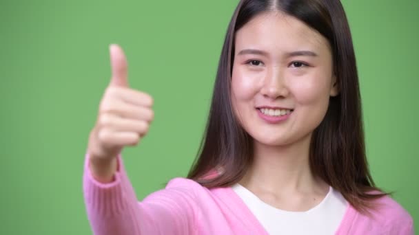 Young beautiful Asian woman giving thumbs up — Stock Video