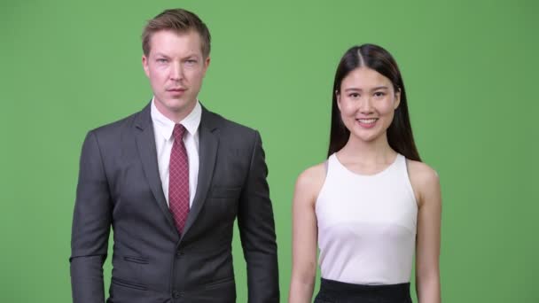 Multi-ethnic business couple giving thumbs up together — Stock Video