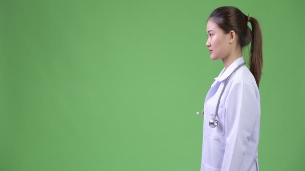 Profilo vista di giovane felice bella donna asiatica medico sorridente — Video Stock