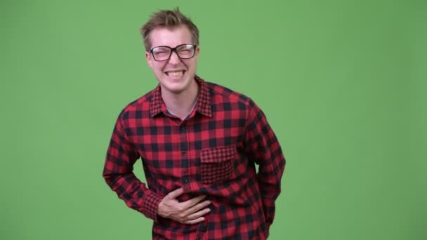 Young handsome nerd man having stomach ache — Stock Video