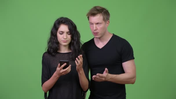 Young couple using phone together — Stock Video