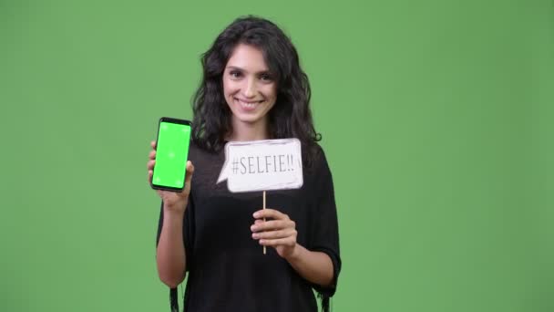 Young beautiful woman showing phone — Stock Video