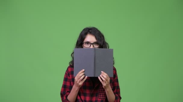 Young beautiful businesswoman covering face with book — Stock Video