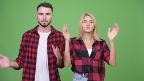 Young couple covering ears together as three wise monkeys concept — Stock Video