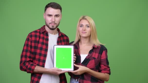 Casal jovem mostrando tablet digital juntos — Vídeo de Stock