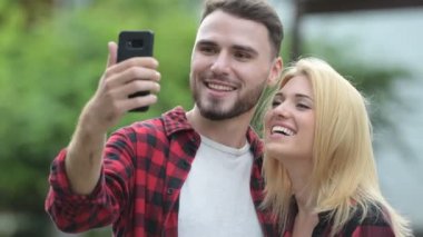 Genç mutlu çift alarak selfie sokaklarda açık havada birlikte