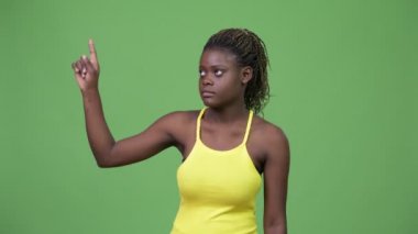 Young African woman pointing up