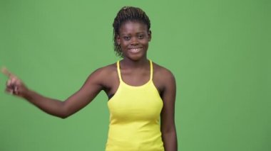 Young African woman pointing up