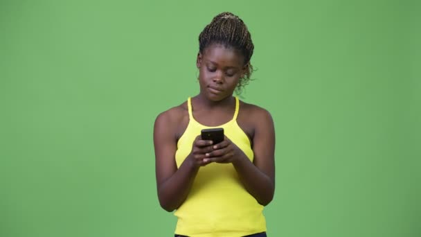 Young African woman using phone — Stock Video