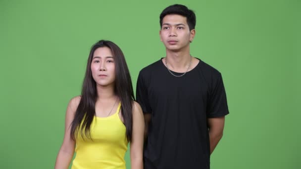 Young Asian couple thinking together — Stock Video