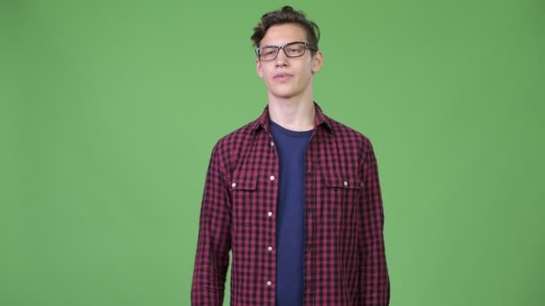 Young handsome teenage nerd boy giving thumbs up — Stock Video