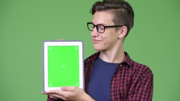 Ung vacker tonårig nörd pojke visar digitala tablett — Stockvideo