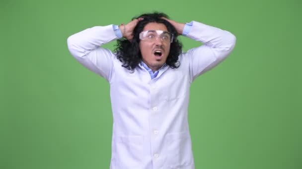 Crazy scientist wearing protective glasses and panicking — Stock Video