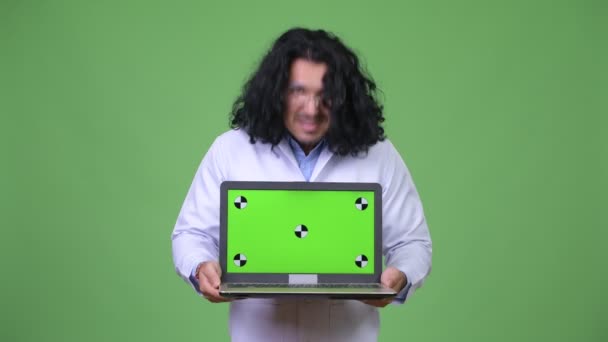 Crazy scientist showing laptop — Stock Video