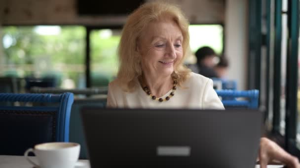 Senior Woman Using Laptop Computer And Mobile Phone — Stock Video