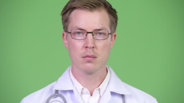 Portrait Of Young Man Doctor Covering Eyes — Stock Video