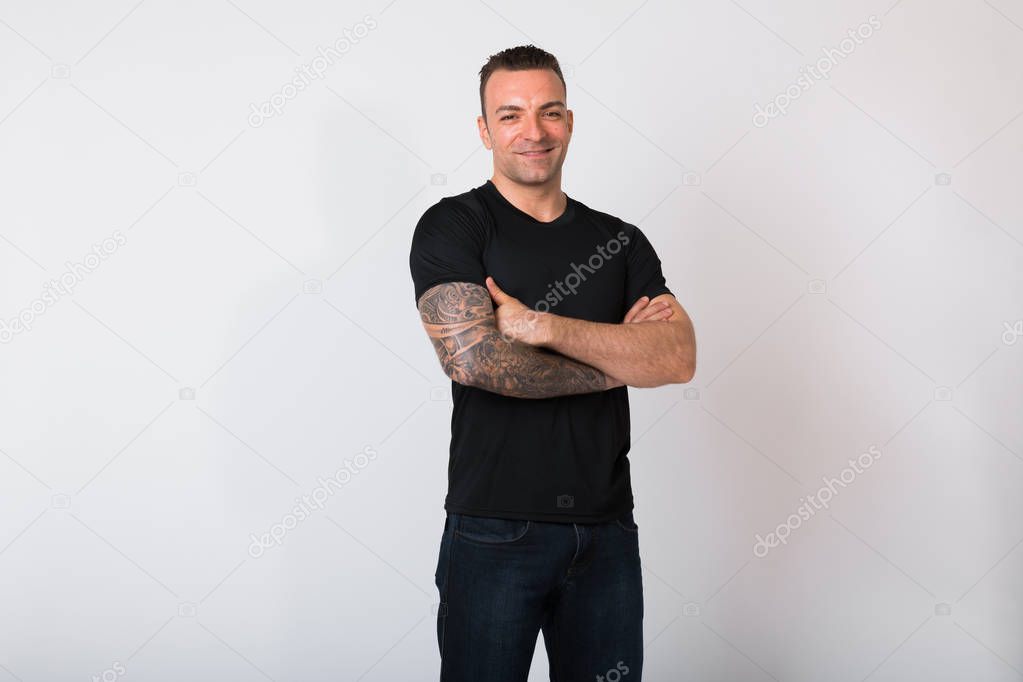 Portrait Of Handsome Man With Tattoos Against White Background