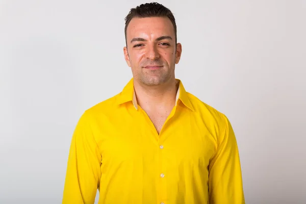 Portrait Of Man Wearing Yellow Shirt Against White Background — Stock Photo, Image