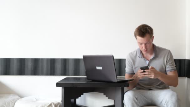 Young Man Sitting And Using Mobile Phone — Stock Video