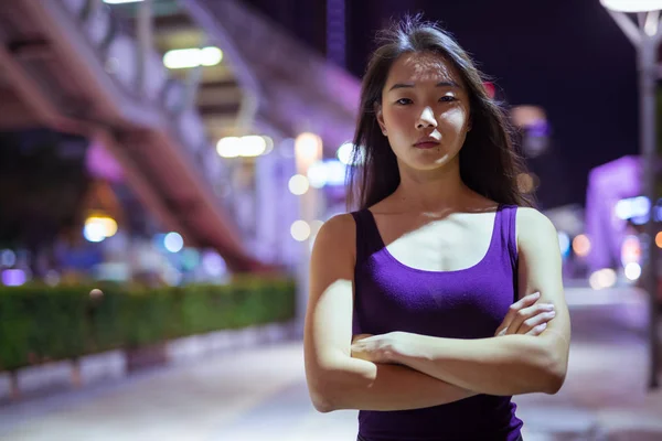 Portrait Of Beautiful Asian Woman Outdoors At Night