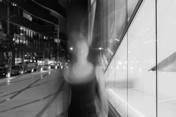 Black And White Long Exposure Portrait With Motion Blur Of Asian Woman At Night