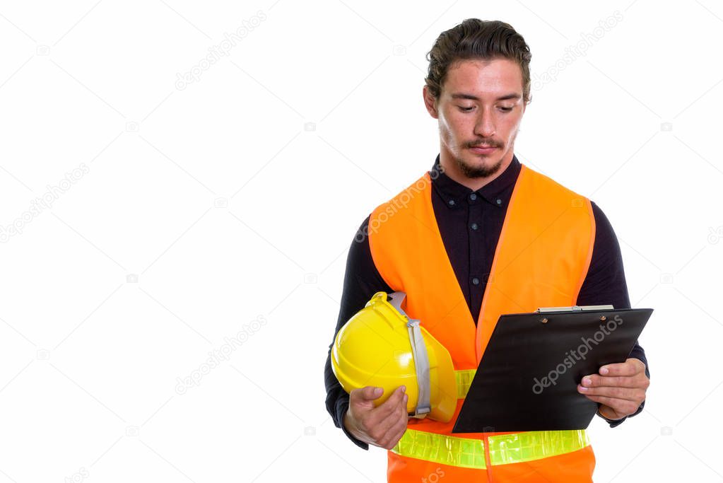 Studio shot of young handsome man construction worker holding ha
