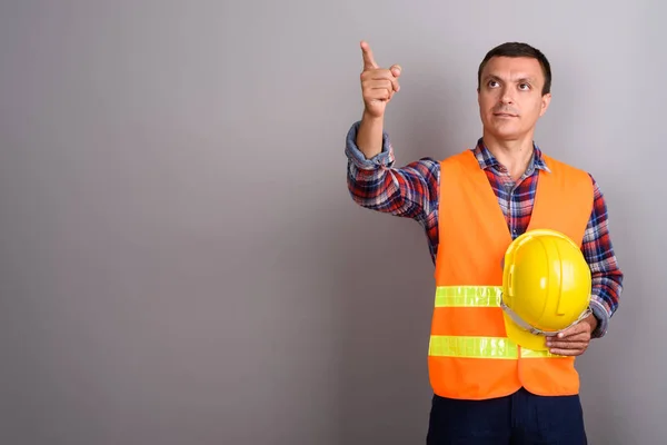 Hombre trabajador de la construcción contra fondo gris —  Fotos de Stock