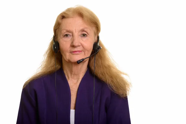 Senior businesswoman wearing headphones working in call center — Stock Photo, Image