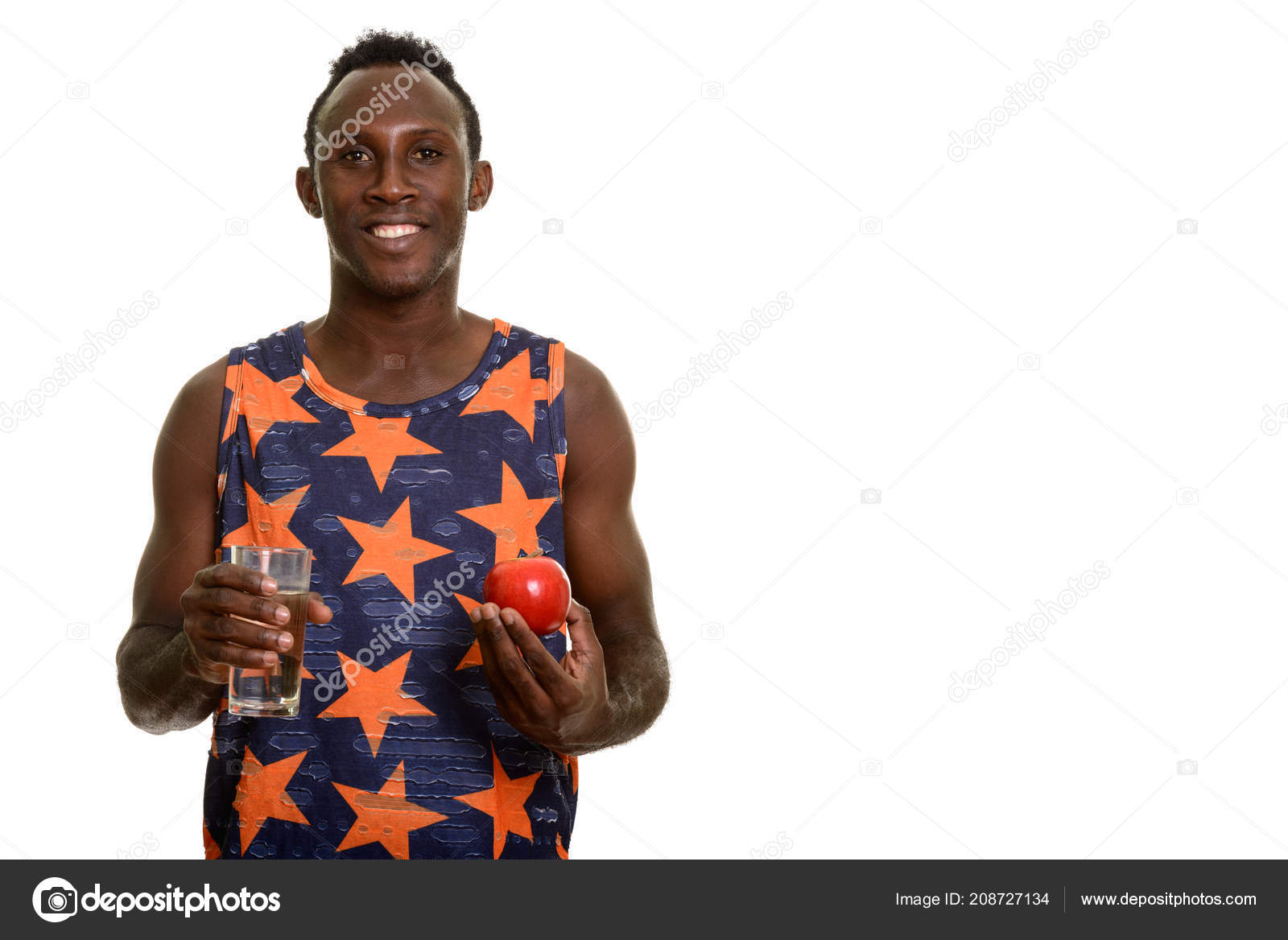 Young Happy Black African Man Smiling While Holding Glass Of Wat