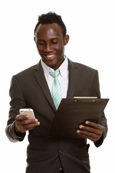 幸せな若いアフリカの実業家笑顔と携帯電話 w を使用 ストック写真