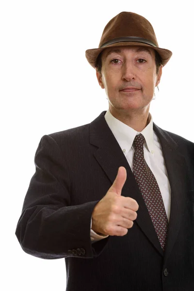 Studio shot of mature businessman giving thumb up — Stock Photo, Image