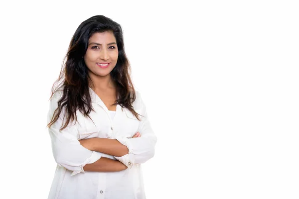 Studio shot of young happy Persian woman smiling with arms cross — Stock Photo, Image