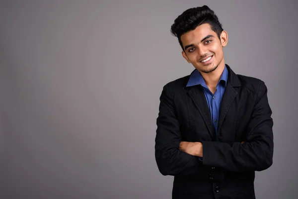 Joven empresario indio contra fondo gris — Foto de Stock