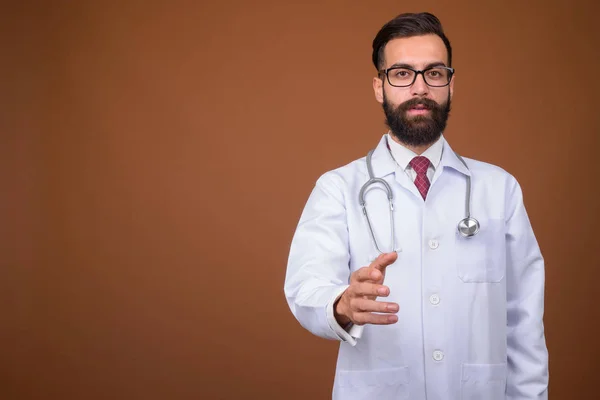 Studio Shot Young Handsome Bearded Persian Man Doctor Brown Background — Stock Photo, Image