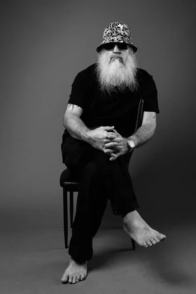Black and White Portrait Of Mature Bald Man With Long Beard Sitting — стоковое фото