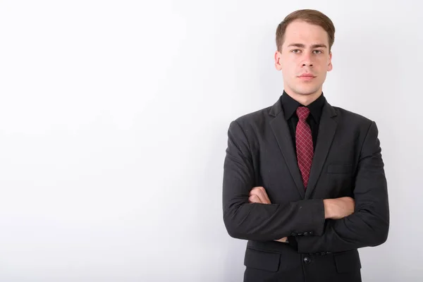 Junger gutaussehender Geschäftsmann im Anzug vor weißem Hintergrund — Stockfoto