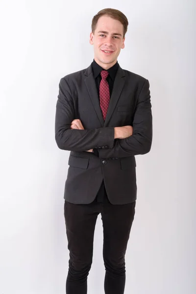 Joven hombre de negocios guapo usando traje contra fondo blanco — Foto de Stock
