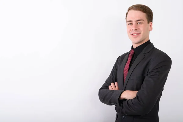 Joven hombre de negocios guapo usando traje contra fondo blanco — Foto de Stock